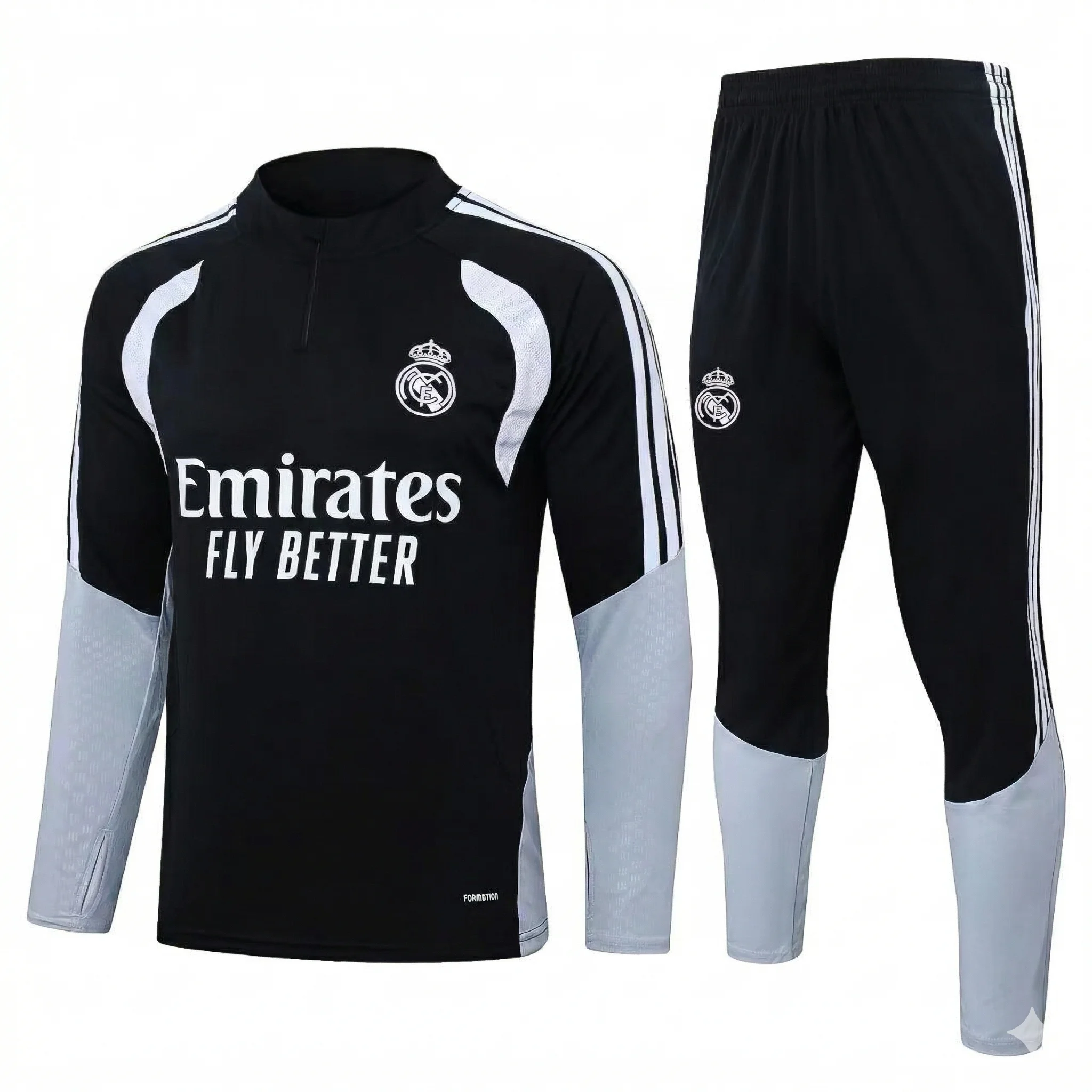 A detailed photographic view of a custom-designed Real Madrid black and grey training tracksuit set, comprising a long-sleeved, quarter-zip top and matching trousers, as seen in image_2.png, with all manufacturer (Adidas) logos meticulously removed. The top features the white Real Madrid club crest on the chest, the white 'Emirates FLY BETTER' sponsor text, and retains its white and grey geometric paneling and white 3-stripes without any Adidas branding. The lower sleeves are light grey. The matching black trousers feature the white club crest and white 3-stripes, with light grey lower leg panels, also unbranded. The set is presented on a clean white background.